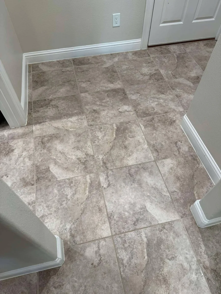 Freshly deep-cleaned tile floor and grout lines in a Weeki Wachee, FL home entryway after professional tile cleaning by Empire DLC Cleanings