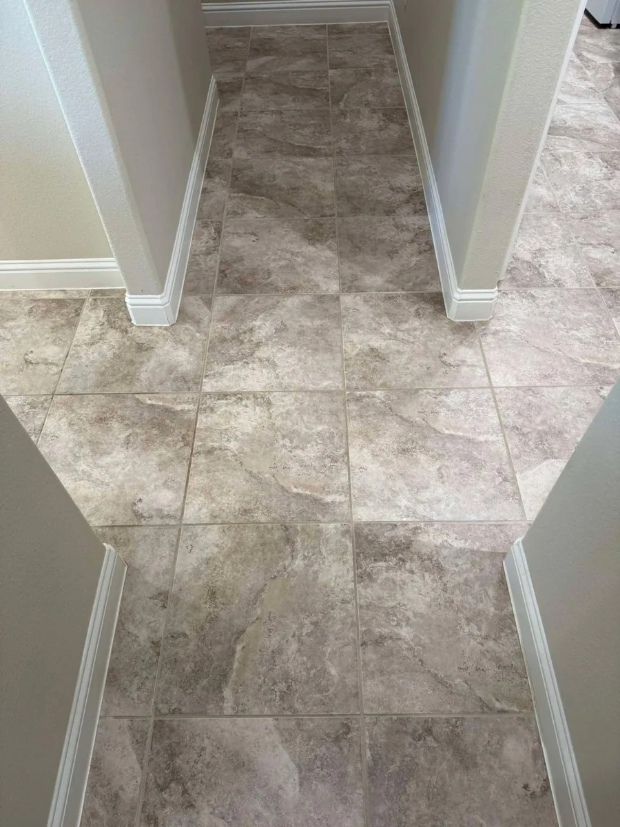 Clean stone-look tile hallway with bright, even grout lines after professional tile and grout cleaning in Weeki Wachee, FL by Empire DLC Cleanings