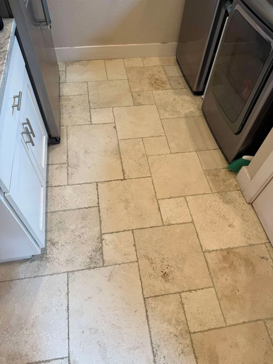 Laundry room travertine tile and grout cleaning in Brooksville, FL by Empire DLC Cleanings